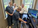 Tony Brock-Fisher, K1KP, (left, front) looks on as Steve Hicks, N5AC (right, front) demonstrates features of the FLEX-8600 to ARRL President Rick Roderick, K5UR (left, rear) and ARRL CEO David Minster, NA2AA (right, rear).